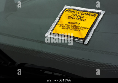 Parking ticket stuck on car windscreen a penalty or fine Stock Photo