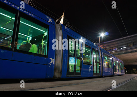 Tram at the quay, at night, Montpellier, France Stock Photo