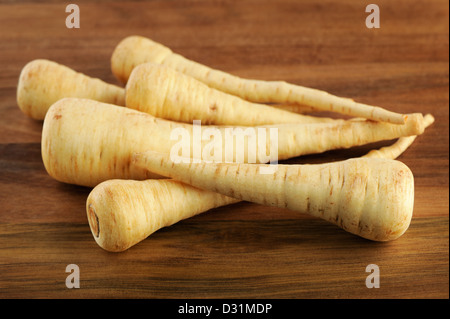 Parsnip on a wooden background, selective focus. Stock Photo