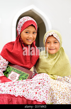 Muslim children sitting outside the Mosque Stock Photo