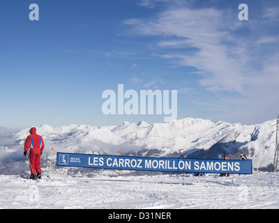 Skier by sign to Samoëns, Morillon and Les Carroz on Grands Vans in Le Grand Massif ski area in French Alps above Flaine, France Stock Photo