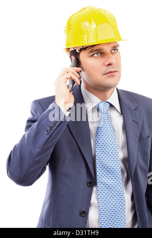 Portrait of a young engineer talking on the phone against white background Stock Photo
