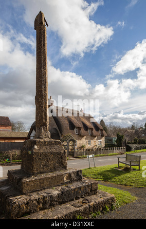 Ancient stone cross from the entrance to the Church of St Peter, Ashton under Hill, Worcestershire, England, UK Stock Photo