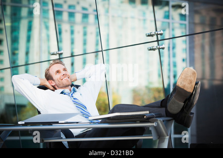 Caucasian businessman relaxing at desk Stock Photo