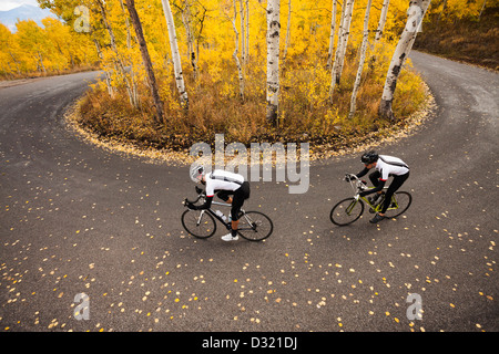 Caucasian cyclists on rural road Stock Photo