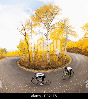 Caucasian cyclists on rural road Stock Photo