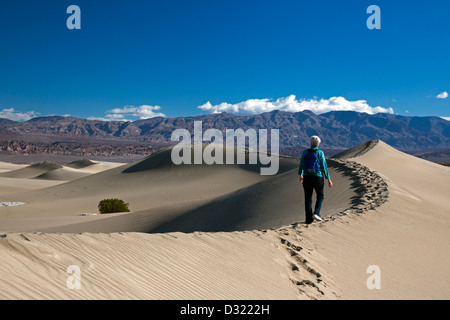 Death Valley National Park, California - Susan Newell, 64, hikes on the Mesquite Flat Sand Dunes. Stock Photo