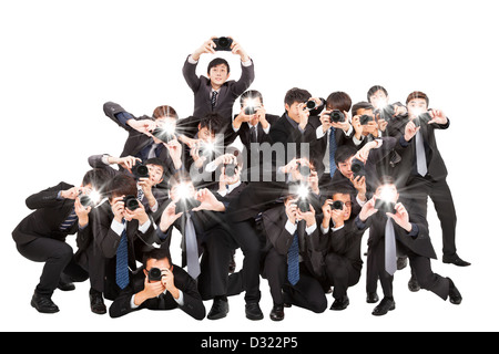 many photographers holding camera pointing to you and isolated on white Stock Photo