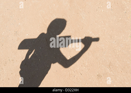 Shadow of young Indian boy with a cricket bat. India Stock Photo
