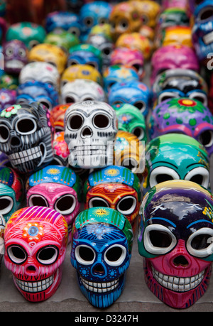Rows of handpainted ceramic skulls for sale during Day of the Dead celebration at market on Zocalo, Oaxaca, Mexico. Stock Photo