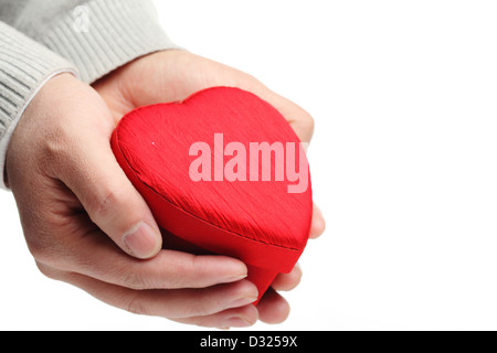 Hand hold heart shaped gift box on white. Stock Photo