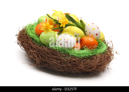 Easter eggs with daffodil flowers on nest Stock Photo