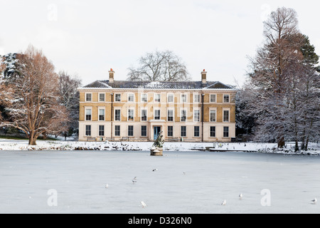 Museum No.1 - snow covered Georgian Brick building next to the frozen pond at Kew Gardens in Winter, Greater London, UK Stock Photo
