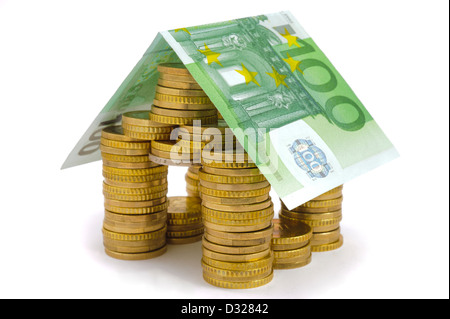 model house built with euro coins and banknote as symbol for finance or real estate Stock Photo