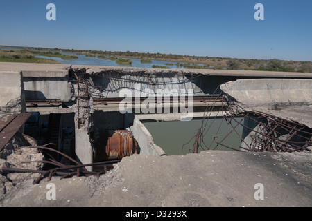 severly damaged section of concrete bridge Stock Photo