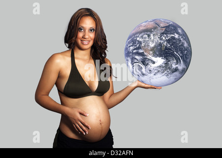 Beautiful Pregnant Woman Holding the Earth in her Hand Stock Photo