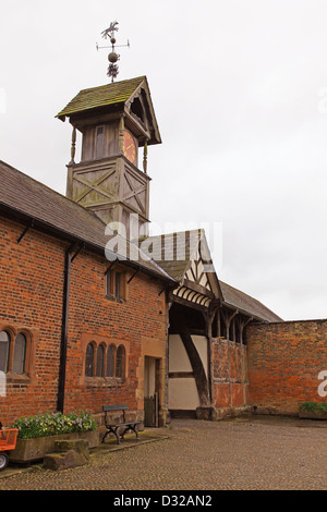 The Clock Tower and entrance to the Tudor barns at Arley Hall gardens Cheshire England UK Stock Photo