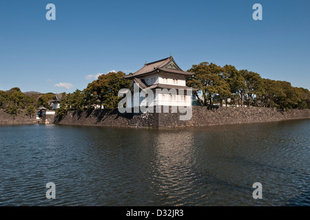 A keep (Tatsumi-nijyu-yagura) on the outer wall above the moat surrounding the Imperial Palace in Tokyo, Japan Stock Photo