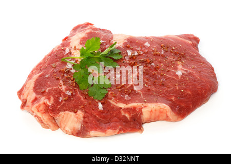 Raw matured rib eye with spices and coriander against white background Stock Photo