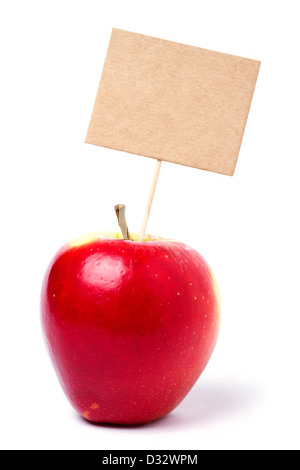 Single ripe apple on white with card on stick Stock Photo