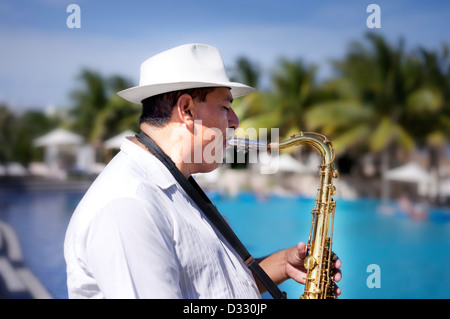 Portrait of man playing Saxophone at beach Stock Photo