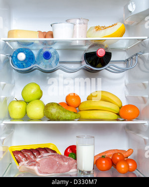 Open fridge full of fruits, vegetables and meat with marked calories Stock Photo