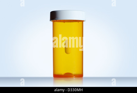 Pill floating in empty prescription bottle Stock Photo