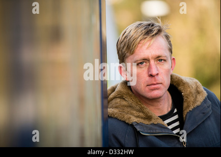 A slim blonde man male, late 30's / early 40's, single solo alone, looking sad UK Stock Photo