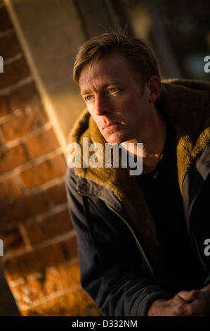 A slim blonde man male, late 30's / early 40's, single solo alone, looking sad UK Stock Photo