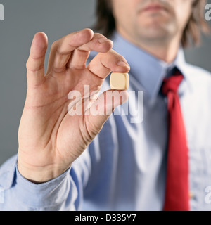 Businessman in blue shirt holding gambling dice, business gambling concept. Stock Photo