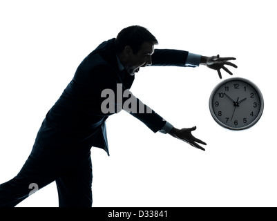 one  businessman running after time in silhouette studio isolated on white background Stock Photo