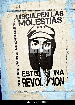 striking torn black & white revolutionary poster announcing long ago demonstration on pale blue plaster wall Oaxaca Mexico Stock Photo