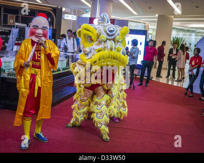 Feb. 7, 2013 - Bangkok, Thailand - Chinese Lion Dancers perform in the Siam Paragon Mall in Bangkok. The weeks surrounding Chinese New Year are important for retailers in Thailand and many malls put on special promotions and events honoring Chinese culture, like Lion Dances or Chinese Opera. Thailand has a large Thai-Chinese population. Millions of Chinese emigrated to Thailand (then Siam) in the 18th and 19th centuries and brought their cultural practices with them. (Credit Image: © Jack Kurtz/ZUMAPRESS.com) Stock Photo