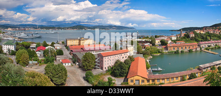 Panorama of navy base on gulf of La Spezia under beautiful blue sky with white clouds on Mediterranean sea in Italy. Stock Photo