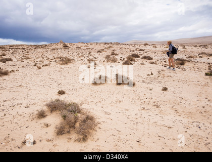 A female tourist hikes in the desert of the Istmo de La Pared. Stock Photo