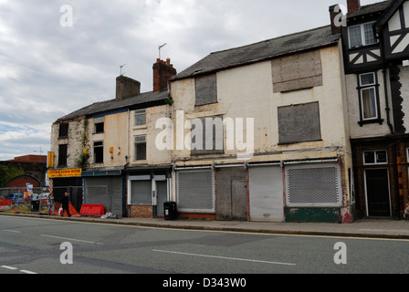 Run down semi derelict buildings in Warrington town centre with boarded up shops. NOW DEMOLISHED - currently a car parking area Stock Photo