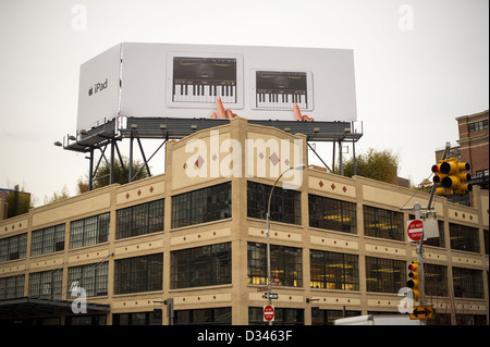 Advertising for the Apple iPad Mini and the full-size iPad on a billboard atop an Apple store Stock Photo