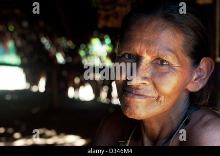 A Yagua elder woman inside a maloca, surroundings of Iquitos, Amazonian Peru Stock Photo