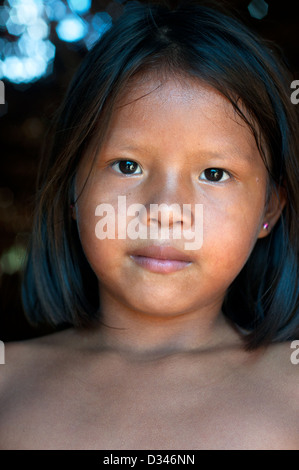 A Yagua young girl inside a maloca (traditional house with thatched roof), surroundings of Iquitos, Amazonian Peru Stock Photo
