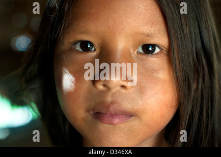 A Yagua young girl inside inside a maloca (traditional house with thatched roof), surroundings of Iquitos Stock Photo