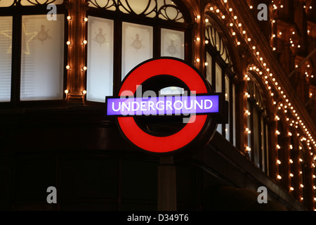 London underground logo with shopping lights as background. It's 150 years since its its first opening. Stock Photo