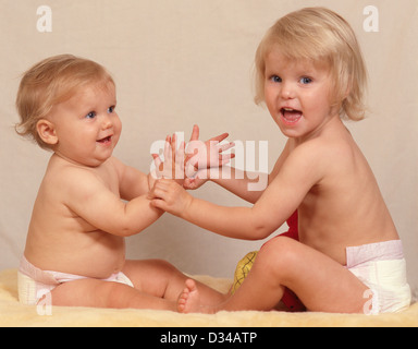 Young female toddlers (sisters) playing together, Winkfield, Berkshire, England, United Kingdom Stock Photo