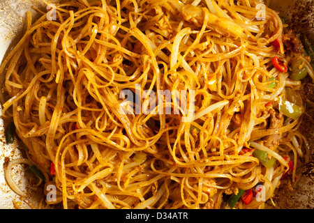 Singapore Curry Noodles in a steel wok Stock Photo