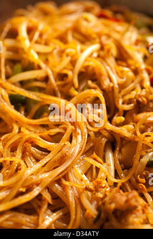 Singapore Curry Noodles in a steel wok Stock Photo