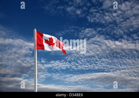 canadian flag against blue sky Stock Photo