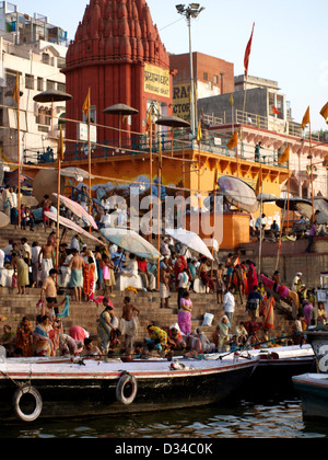 Indian Hindus on ghats at Varanasi, India, during morning puja. Stock Photo