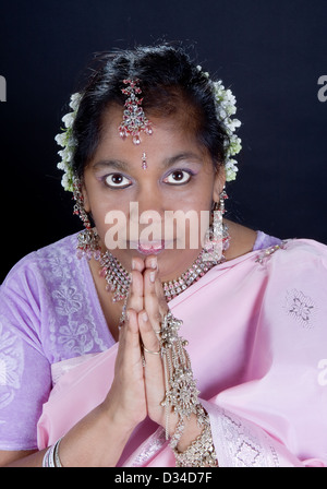 Indian woman in saree with traditional namaste greeting Stock Photo
