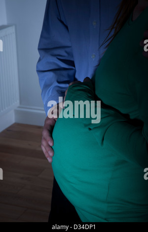 Young pregnant woman and male partner at home. Close up. Stock Photo