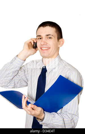 The young man holds in a hand a blue folder with documents and speaks by mobile phone Stock Photo