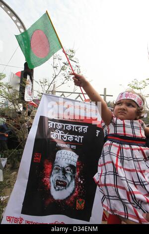 Feb. 8, 2013 - Dhaka, Bangladesh - Bangladeshi child holds the national flag during the 4th day of protest at Shahabag intersection in the capital Dhaka on Friday. Bangladeshi people and bloggers, online activists are demanding capital punishment for war criminal and Jamaat-e-Islami leader Abdul Quader Mollah. International Crimes Tribunal (ICT)-2 on Tuesday sentenced Quader Mollah to life in prison for committing crimes against humanity during the 1971 Liberation War. (Credit Image: © Monirul Alam/ZUMAPRESS.com) Stock Photo